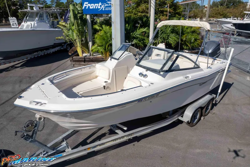 The Image of 2016 Grady-White Freedom 225 boat on trailer at dealership, sunny day. - 0