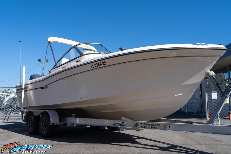 Slide: The Image of 2016 Grady-White Freedom 225 boat on trailer under clear blue sky. - 16