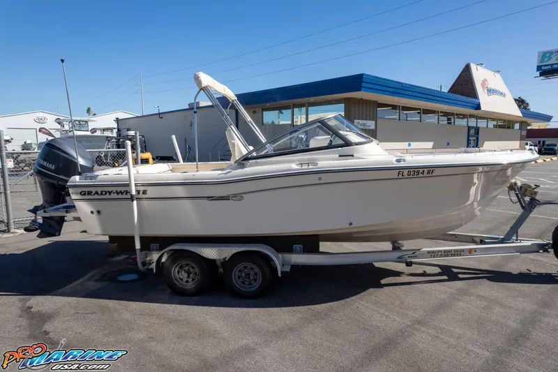 Slide: The Image of 2016 Grady-White Freedom 225 boat on trailer, parked outside a marine dealership. - 18
