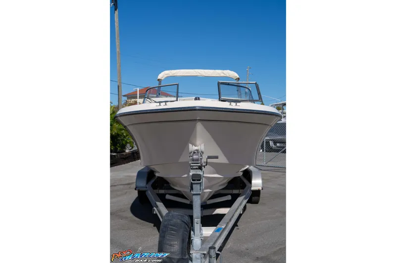 Slide: The Image of 2016 Grady-White Freedom 225 boat on trailer, front view, clear sky background. - 19