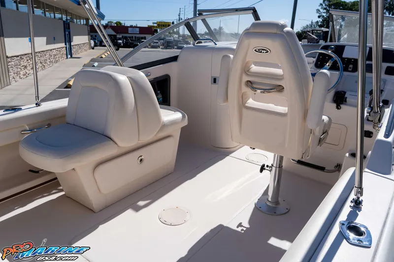 Slide: The Image of 2016 Grady-White Freedom 225 boat interior with seating and steering console. - 28