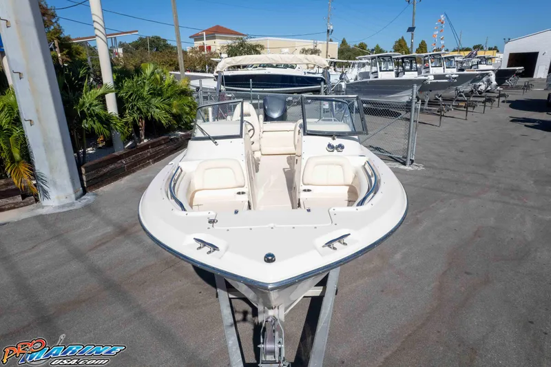 Slide: The Image of 2016 Grady-White Freedom 225 boat displayed at a marina, surrounded by other vessels. - 29