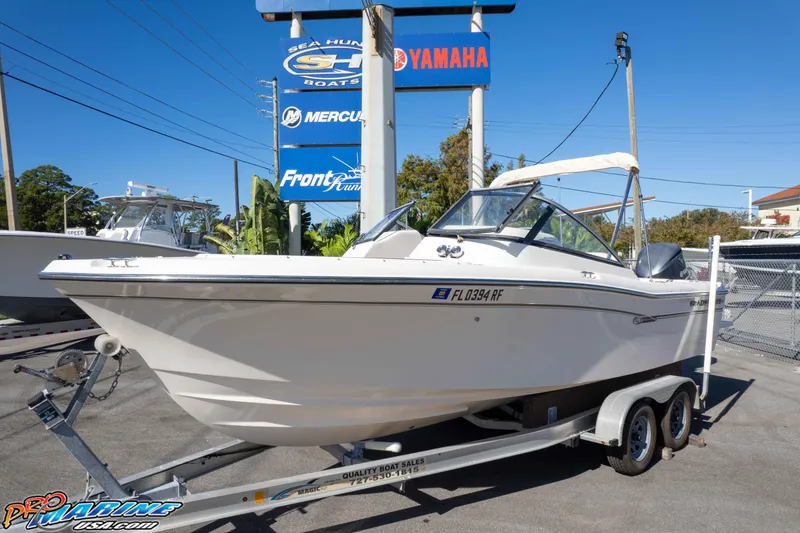 Slide: The Image of 2016 Grady-White Freedom 225 boat on trailer at dealership, featuring Yamaha and Mercury signage. - 3