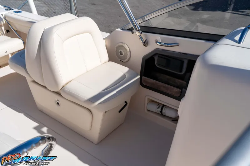 Slide: The Image of 2016 Grady-White Freedom 225 boat interior with white seating and storage compartments. - 33