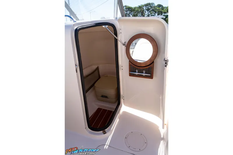 Slide: The Image of 2016 Grady-White Freedom 225 boat interior with porthole and storage compartment. - 37