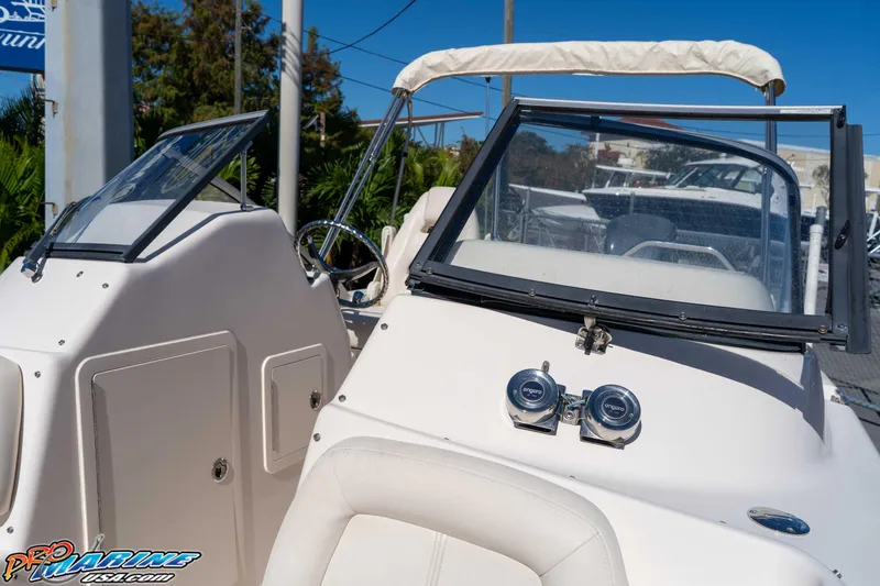 Slide: The Image of 2016 Grady-White Freedom 225 boat with dual consoles and windshield, docked outdoors. - 40