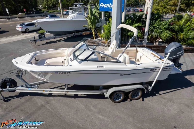 Slide: The Image of 2016 Grady-White Freedom 225 boat on trailer, parked outdoors. - 7