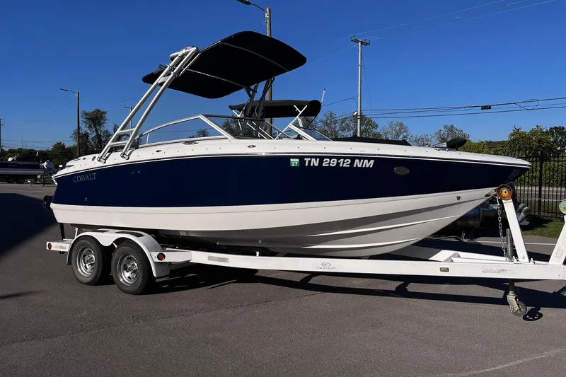 The Image of 2008 Cobalt 202 boat on trailer, blue and white, parked outdoors. - 0