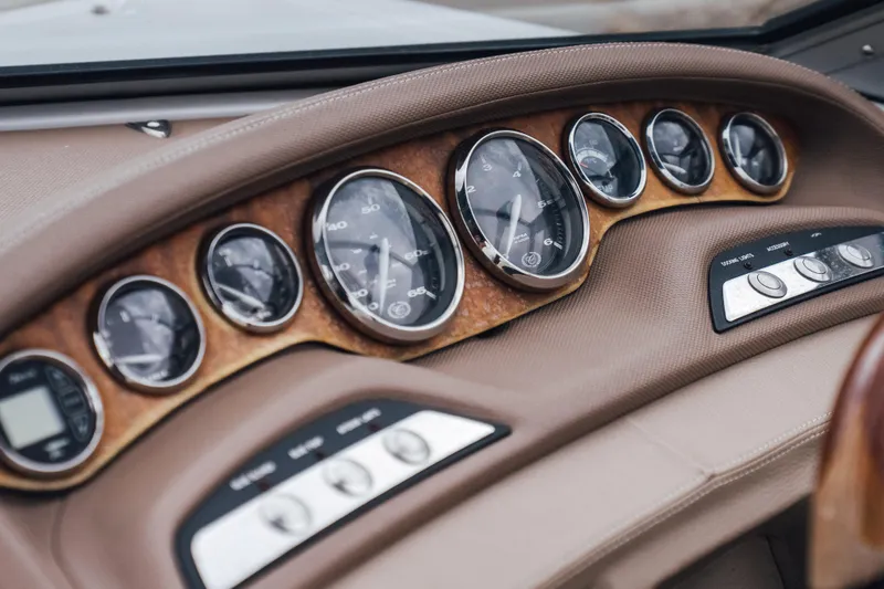 Slide: The Image of Dashboard of a 2008 Cobalt 202 boat with classic gauges and controls. - 12