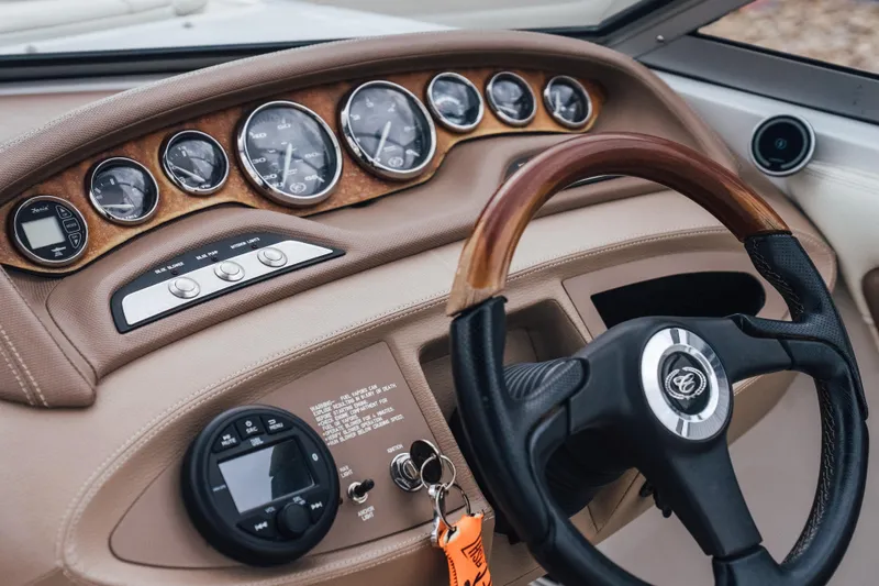 Slide: The Image of Dashboard of a 2008 Cobalt 202 boat with wood-accented steering wheel and gauges. - 13