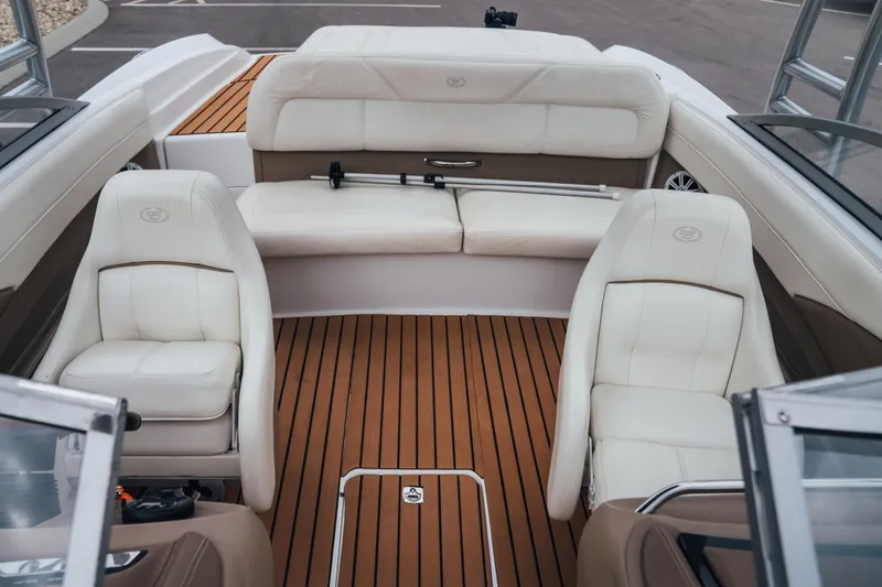 Slide: The Image of Interior of a 2008 Cobalt 202 boat with white leather seats and wooden flooring. - 15