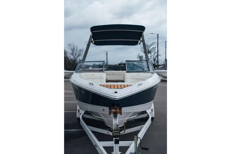 Slide: The Image of 2008 Cobalt 202 boat on trailer, parked outdoors under cloudy sky. - 19