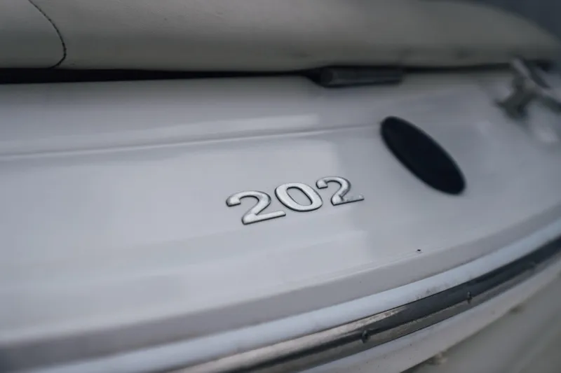 Slide: The Image of Close-up of a 2008 Cobalt 202 boat emblem on a white surface. - 21