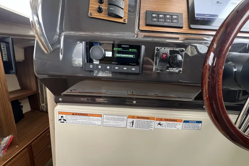 Slide: The Image of 2025 Ranger Tugs R-27 Luxury Edition dashboard with controls and warning labels. - 18