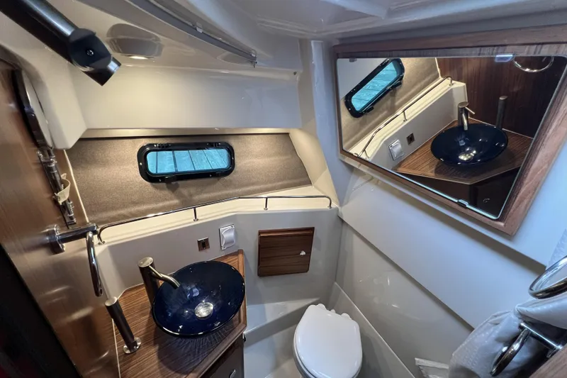 Slide: The Image of Luxurious bathroom in 2025 Ranger Tugs R-27, featuring modern sink and elegant wood accents. - 19