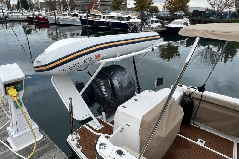 Slide: The Image of 2025 Ranger Tugs R-27 Luxury Edition docked with Yamaha outboard and inflatable boat. - 6