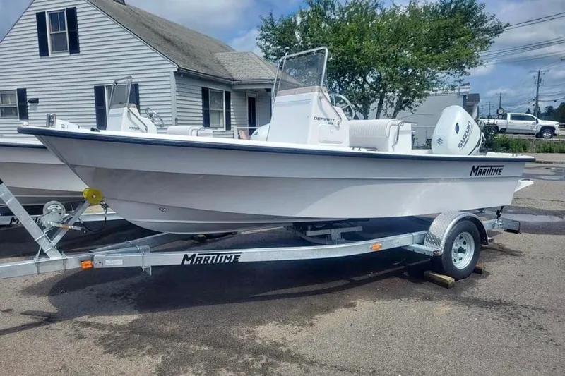 The Image of 2024 Maritime 189 Defiant boat on trailer, parked near a house. - 0