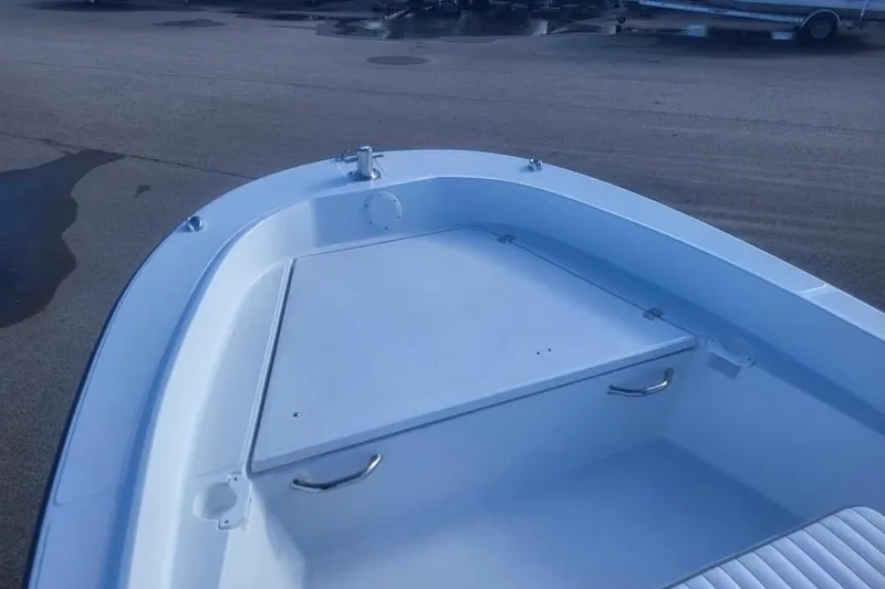 Slide: The Image of 2024 Maritime 189 Defiant boat interior, featuring a sleek white deck and storage compartment. - 3