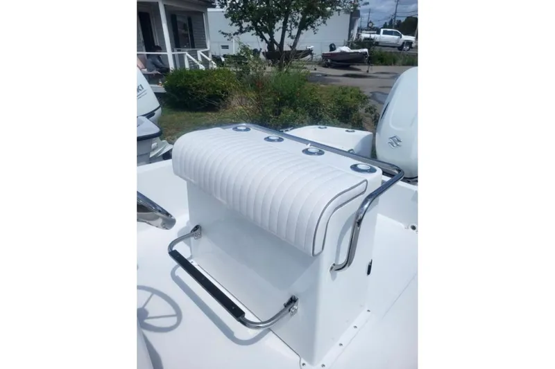 Slide: The Image of 2024 Maritime 189 Defiant boat seat with white upholstery and stainless steel accents. - 5
