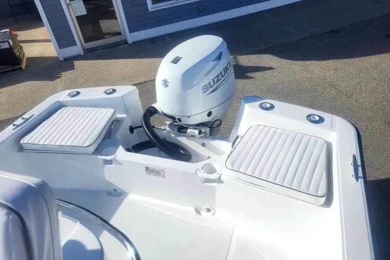 Slide: The Image of 2024 Maritime 189 Defiant boat with Suzuki outboard motor and cushioned seating. - 6