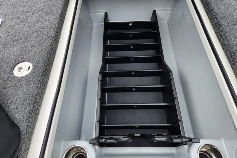 Slide: The Image of 2026 Triton 19 TrX Patriot boat storage compartment with organized dividers. - 10