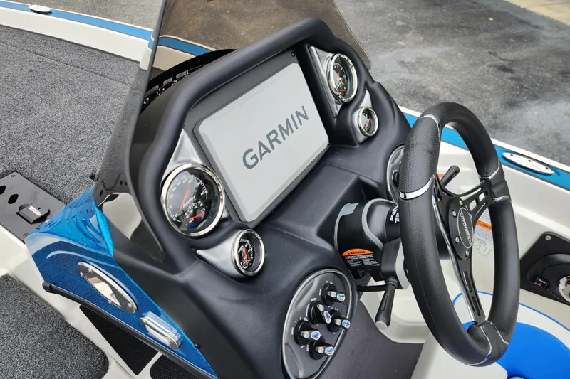 Slide: The Image of 2026 Triton 19 TrX Patriot dashboard with Garmin display and steering wheel. - 13