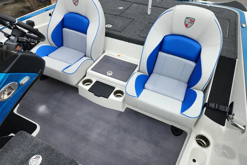 Slide: The Image of 2026 Triton 19 TrX Patriot boat interior with blue and white seating. - 14