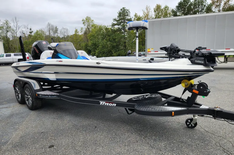 Slide: The Image of 2026 Triton 19 TrX Patriot boat on trailer, featuring sleek design and modern equipment. - 6