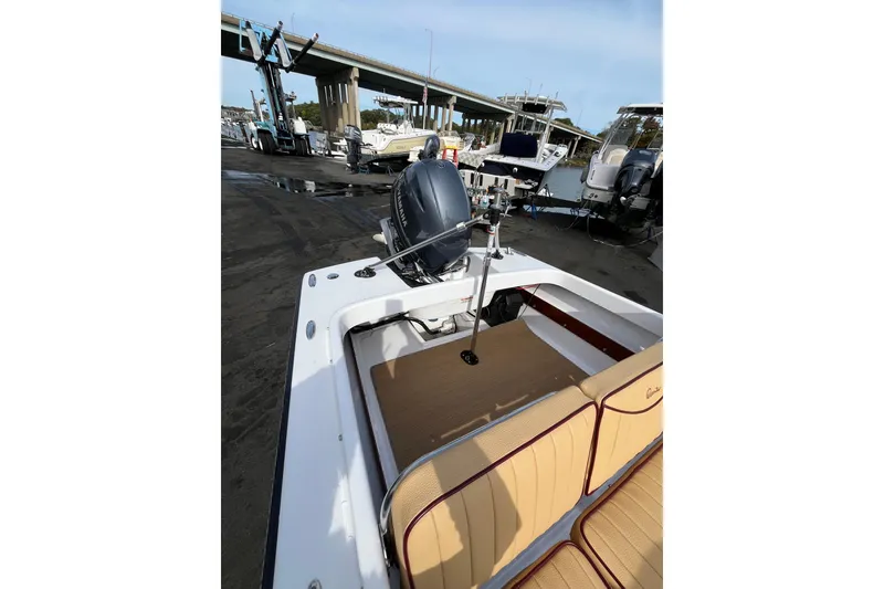 Slide: The Image of 2023 Rossiter 14 boat with outboard motor, docked near other vessels. - 8