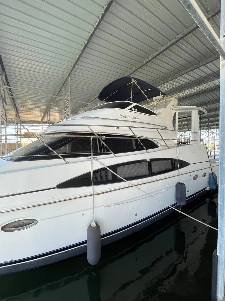 Slide: The Image of 2001 Carver 444 Cockpit Motor Yacht docked in covered marina. - 13