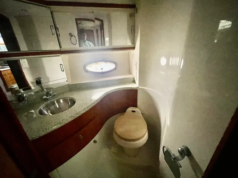 Slide: The Image of 2001 Carver 444 Cockpit Motor Yacht bathroom with sink, toilet, and mirror. - 23