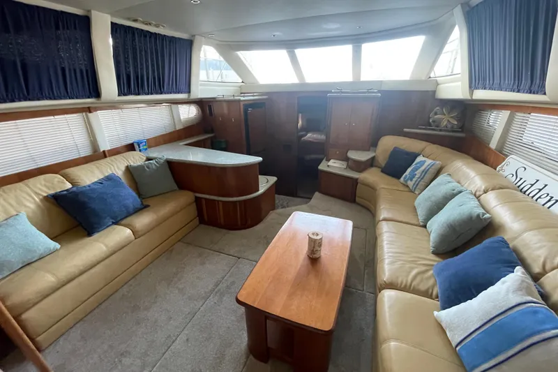 Slide: The Image of Luxurious interior of 2001 Carver 444 Cockpit Motor Yacht with plush seating and elegant decor. - 26