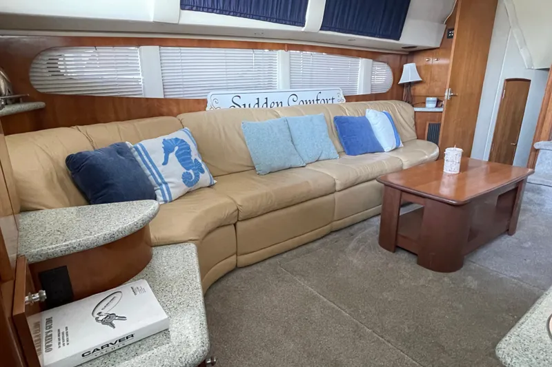 Slide: The Image of Interior of 2001 Carver 444 Cockpit Motor Yacht with beige sofa and blue cushions. - 27