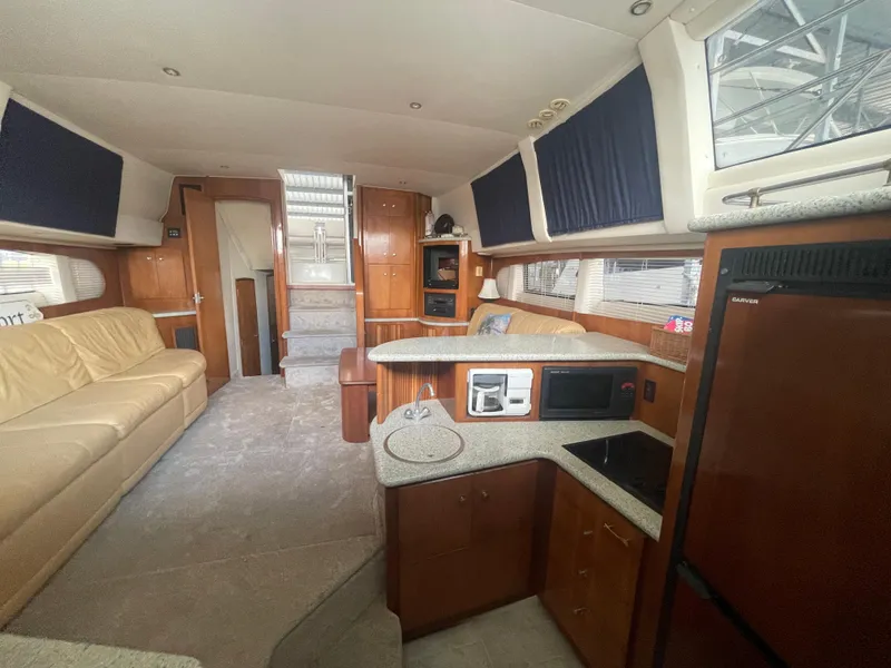 Slide: The Image of Interior of 2001 Carver 444 Cockpit Motor Yacht with modern kitchen and seating area. - 28