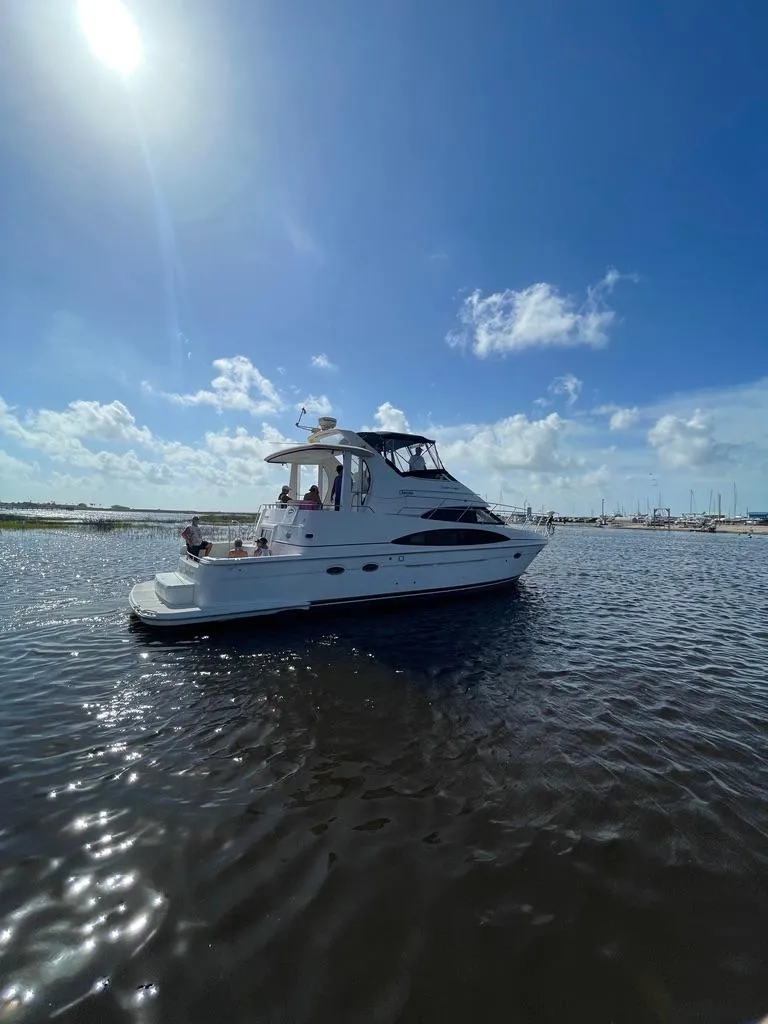 Slide: The Image of 2001 Carver 444 Cockpit Motor Yacht on calm water under blue sky. - 3
