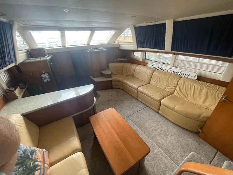 Slide: The Image of Interior of 2001 Carver 444 Cockpit Motor Yacht with beige leather seating and wood accents. - 31