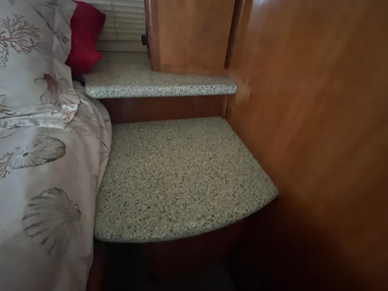 Slide: The Image of Interior of 2001 Carver 444 Cockpit Motor Yacht with bed and wooden cabinetry. - 40