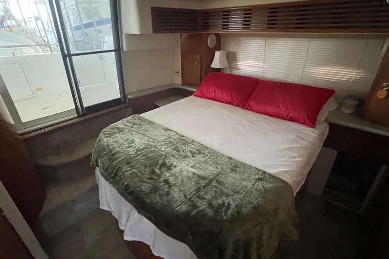 Slide: The Image of Cozy bedroom in 2001 Carver 444 Cockpit Motor Yacht with window view. - 41