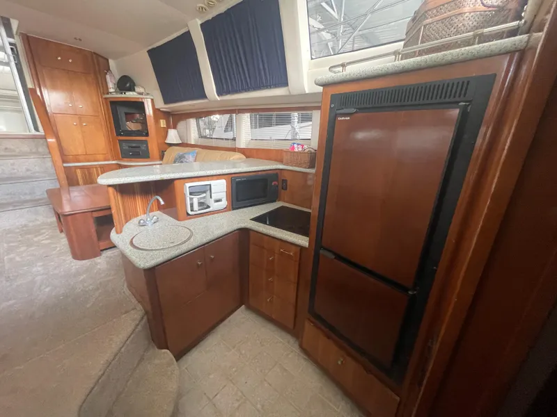 Slide: The Image of Interior of 2001 Carver 444 Cockpit Motor Yacht with kitchen amenities. - 29