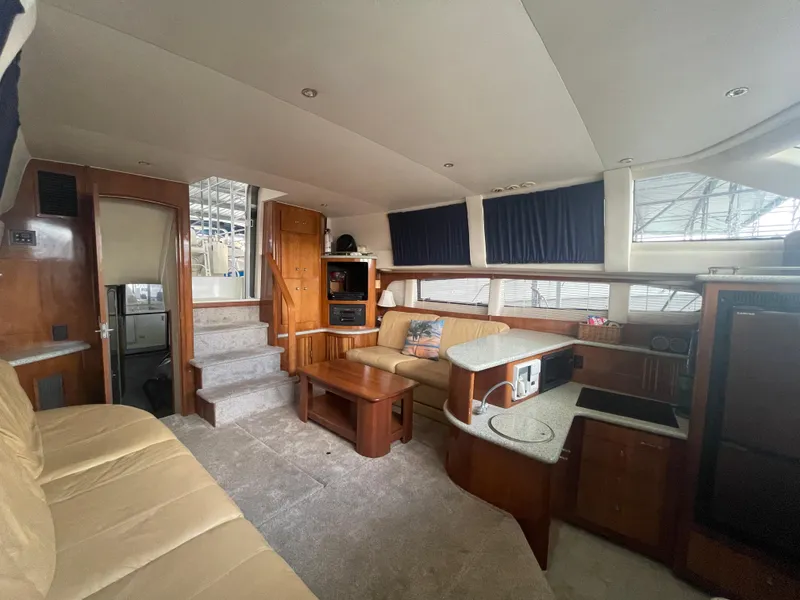 Slide: The Image of Interior of 2001 Carver 444 Cockpit Motor Yacht with cozy seating and wooden accents. - 30