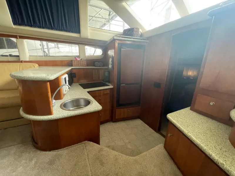 Slide: The Image of Interior of 2001 Carver 444 Cockpit Motor Yacht with modern kitchen amenities. - 33