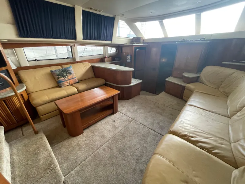 Slide: The Image of 2001 Carver 444 Cockpit Motor Yacht interior with beige seating and wooden accents. - 38