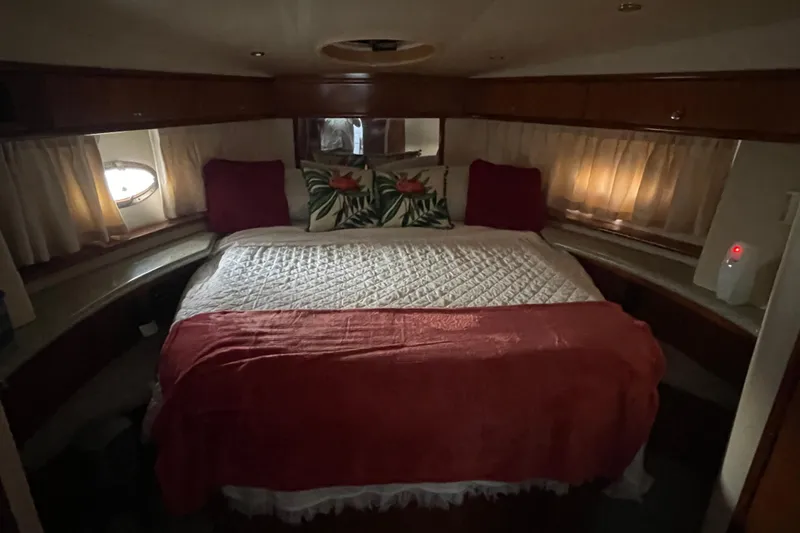 Slide: The Image of Cozy bedroom in 2001 Carver 444 Cockpit Motor Yacht with elegant bedding. - 39
