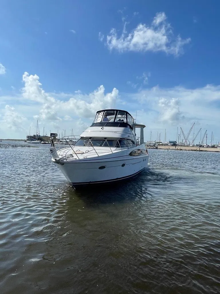 Slide: The Image of 2001 Carver 444 Cockpit Motor Yacht on calm water under blue sky. - 4