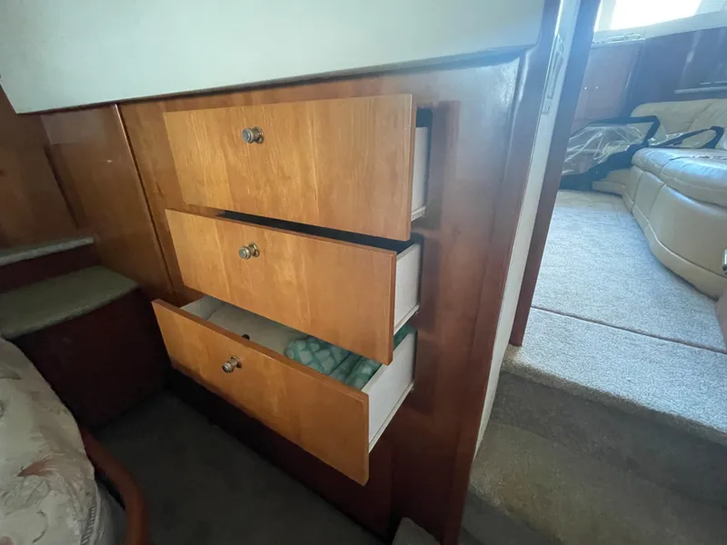 Slide: The Image of Interior view of 2001 Carver 444 Cockpit Motor Yacht with open wooden drawers. - 42