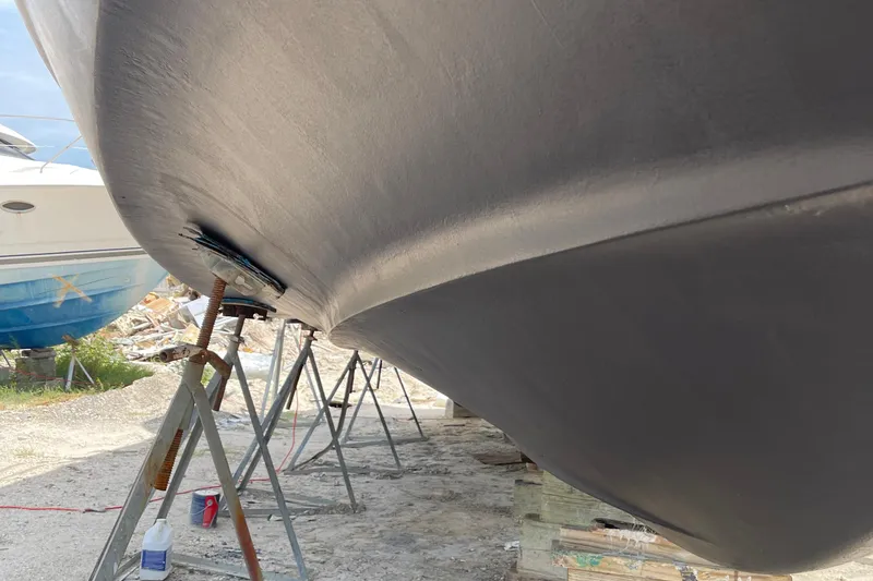 Slide: The Image of 2001 Carver 444 Cockpit Motor Yacht hull on stands, undergoing maintenance. - 44