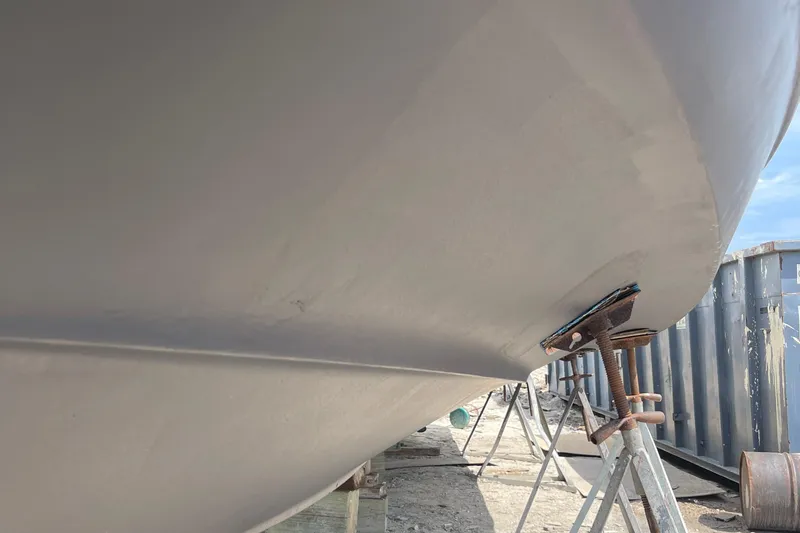 Slide: The Image of 2001 Carver 444 Cockpit Motor Yacht hull on dry dock, supported by stands. - 45