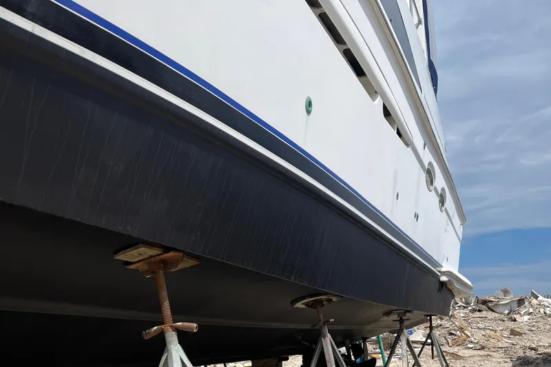 Slide: The Image of 2001 Carver 444 Cockpit Motor Yacht on stands, side view, clear sky background. - 46