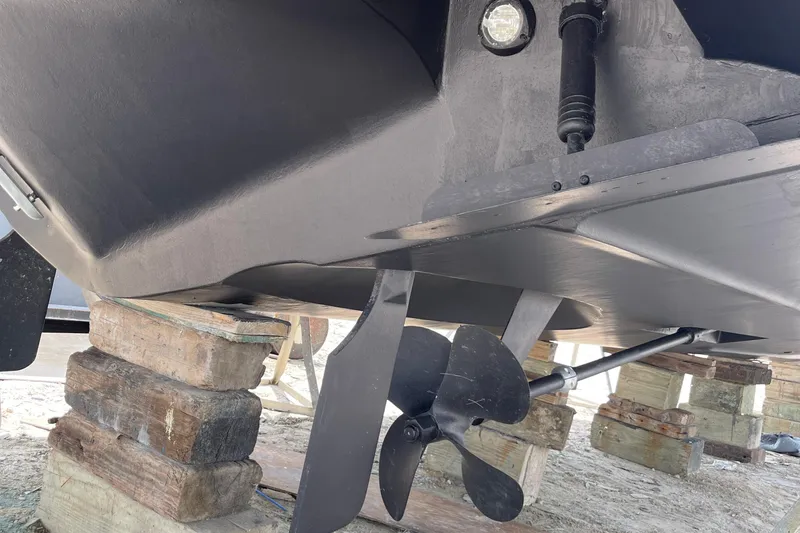 Slide: The Image of 2001 Carver 444 Cockpit Motor Yacht propeller and hull on wooden blocks. - 49