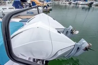 Slide: The Image of 2023 Axopar 37 boat docked in marina, surrounded by other vessels. - 10